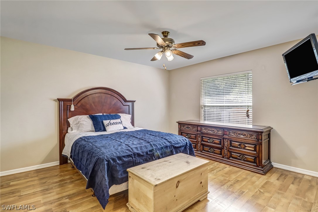 9050 Henry Road Fort Myers, FL 33967 - Photo 9 of 16 a bedroom with a bed and a flat screen tv