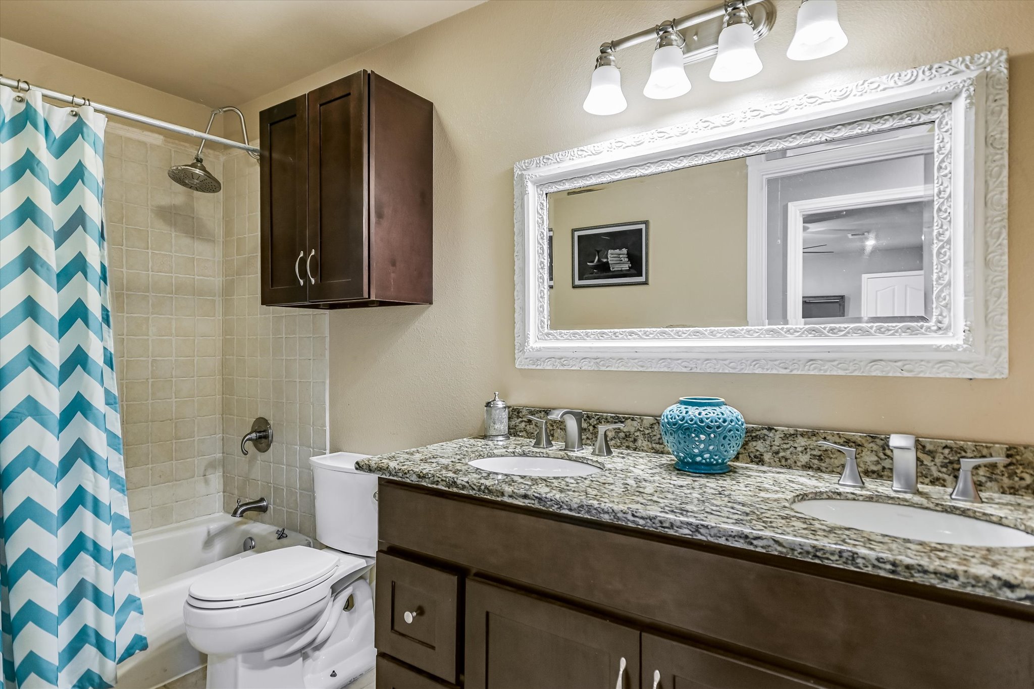 1801 Sun Lake Round Rock, TX 78681 - Photo 19 of 31 Upstairs hall bathroom features a generous double vanity, linen storage cabinet, and tub/shower combo.