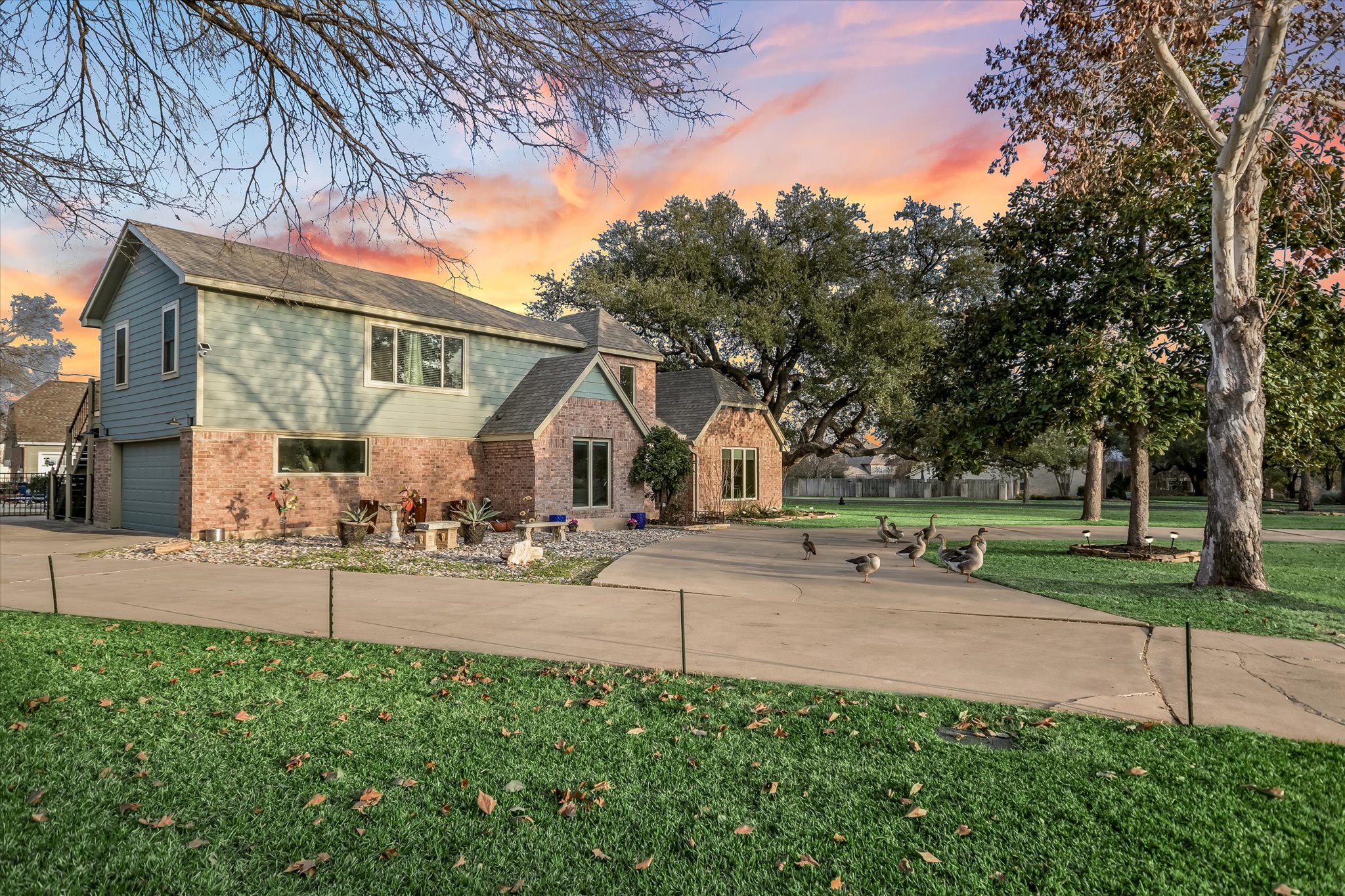 1801 Sun Lake Round Rock, TX 78681 - Photo 2 of 31 Long driveway with side entry garage adjoins the circle drive, and welcomes the neighborhood geese!