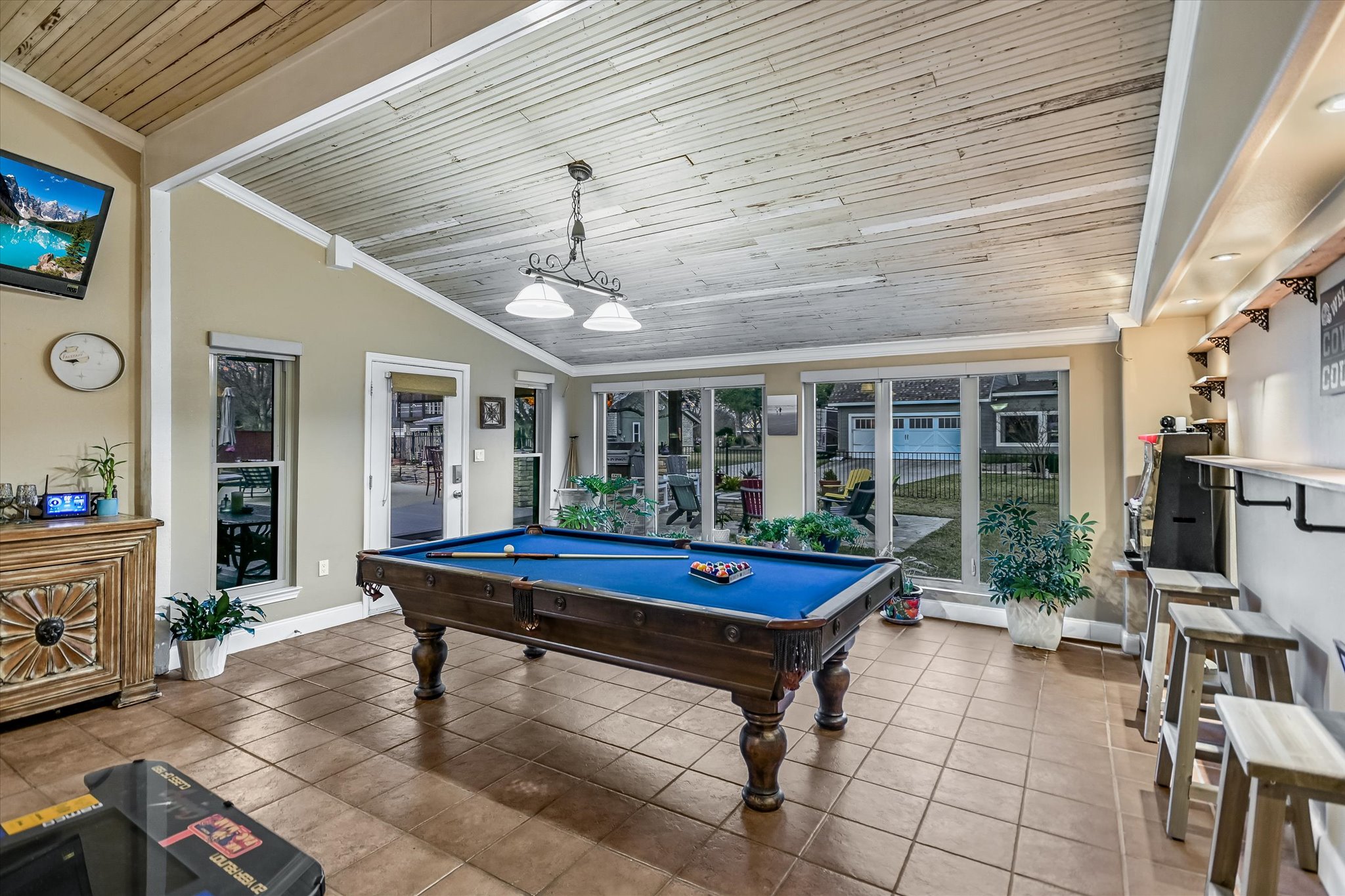 1801 Sun Lake Round Rock, TX 78681 - Photo 23 of 31 The gameroom extends off of the back of the central living area. The ceiling is re-claimed wood from Camp Mabry, and makes an inviting entertaining space that adjoins the house to the wonderful outdoor spaces.