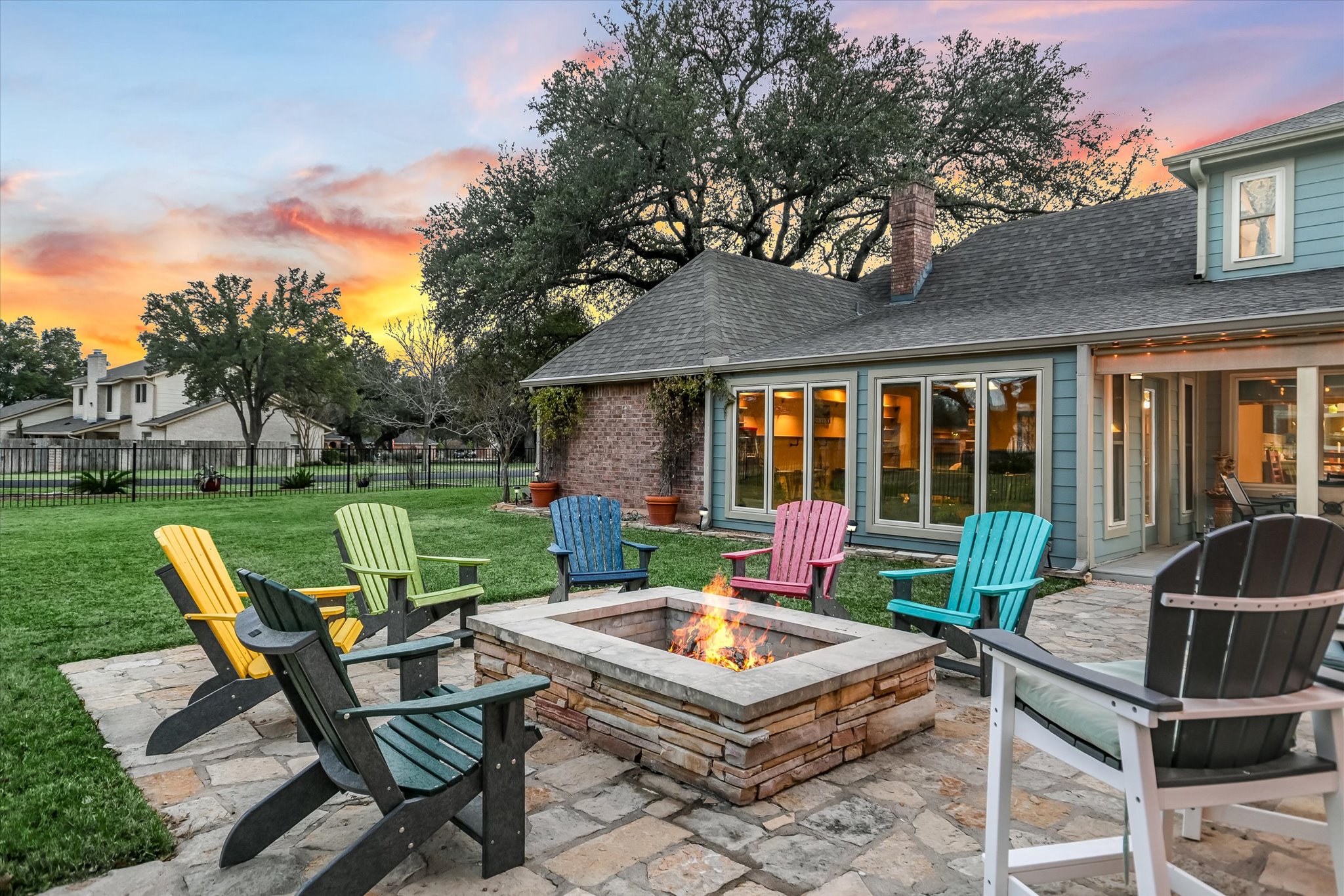 1801 Sun Lake Round Rock, TX 78681 - Photo 30 of 31 Too cold to swim? We got you! Gather around the built-in firepit for a cozy way to catch up with family and friends. The wrought iron fencing makes it easy to connect with neighbors, but the gathering spaces are tucked well inside the yard for privacy.