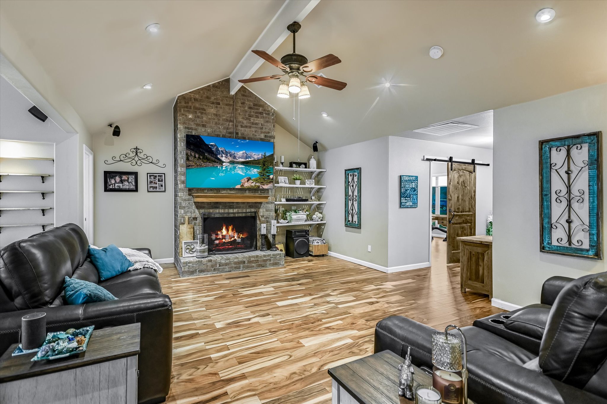 1801 Sun Lake Round Rock, TX 78681 - Photo 7 of 31 Inviting central living area with beautiful brick fireplace and vaulted ceiling and stunning Acacia wood flooring.