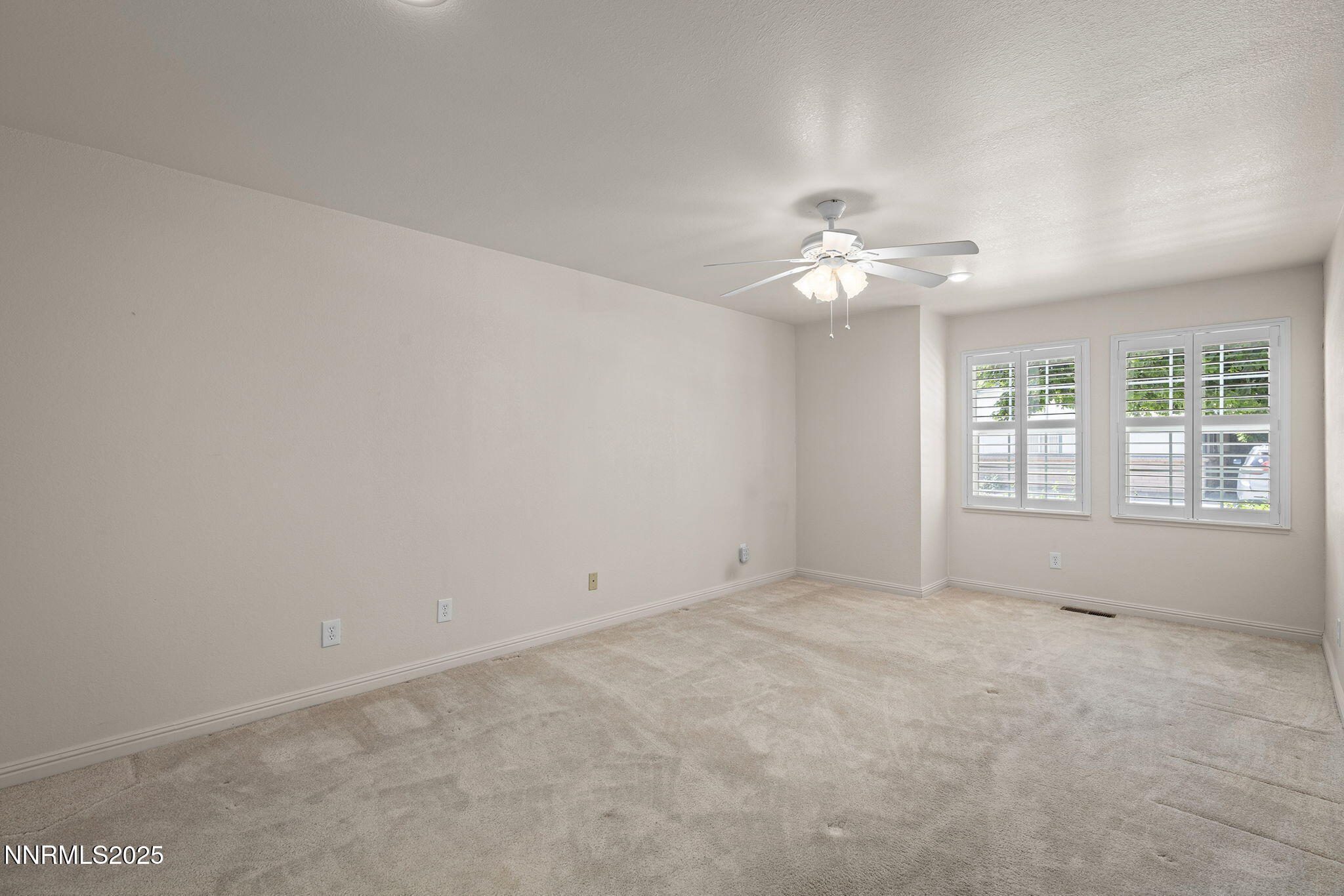 3003 Chubasco Way Carson City, NV 89701 - Photo 16 of 27 an empty room with chandelier fan and windows