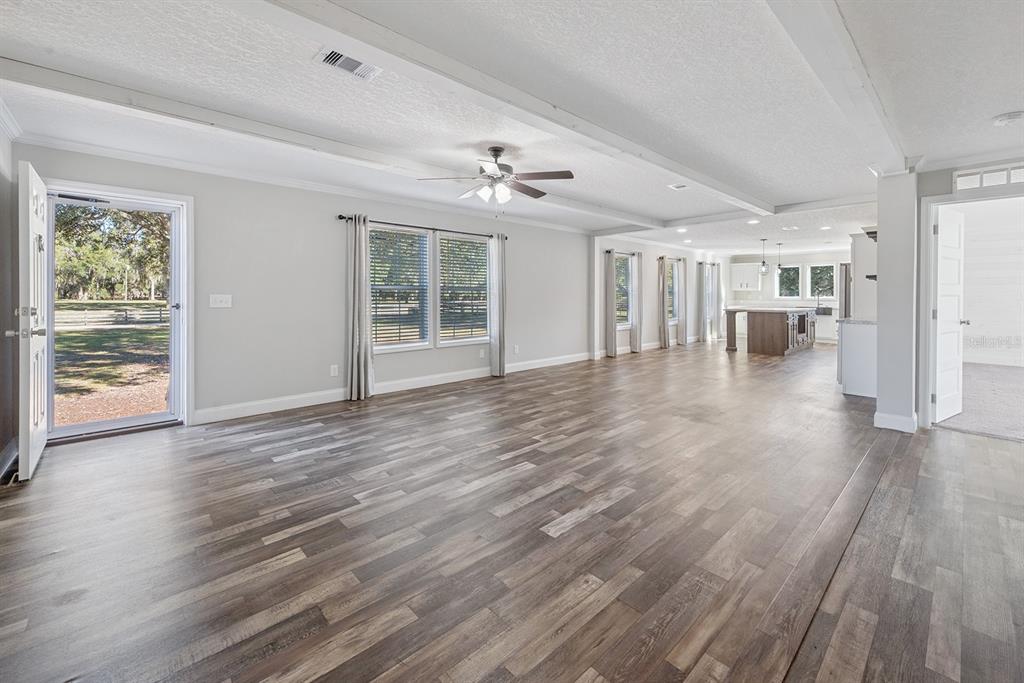 19750 Southeast 30th Street Morriston, FL 32668 - Photo 22 of 52 wooden floor in an empty room with a window