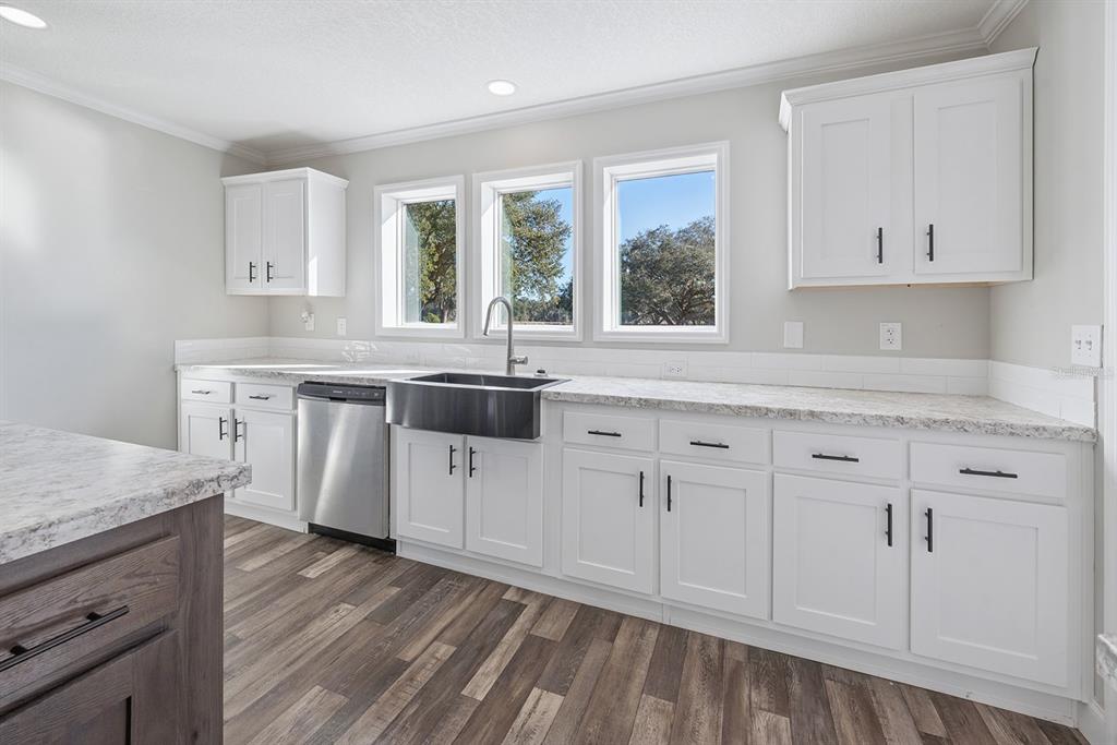 19750 Southeast 30th Street Morriston, FL 32668 - Photo 28 of 52 a kitchen with white cabinets and sink