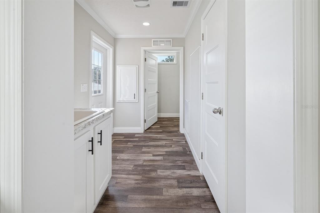 19750 Southeast 30th Street Morriston, FL 32668 - Photo 31 of 52 a view of a hallway with wooden floor and closet
