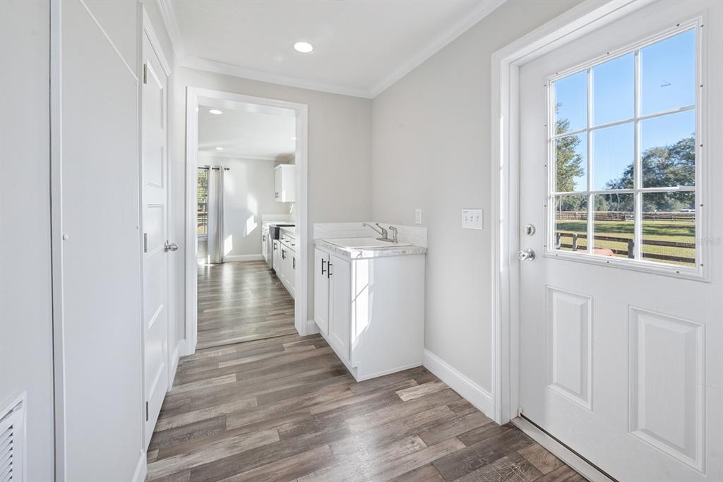 19750 Southeast 30th Street Morriston, FL 32668 - Photo 32 of 52 a view of a hallway with wooden floor and cabinet