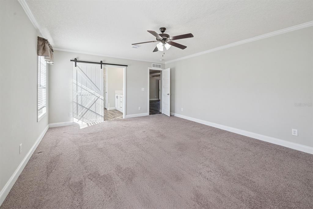 19750 Southeast 30th Street Morriston, FL 32668 - Photo 38 of 52 a view of a livingroom with a ceiling fan and window