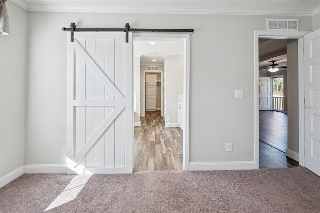 19750 Southeast 30th Street Morriston, FL 32668 - Photo 39 of 52 a view of a hallway with wooden floor and staircase