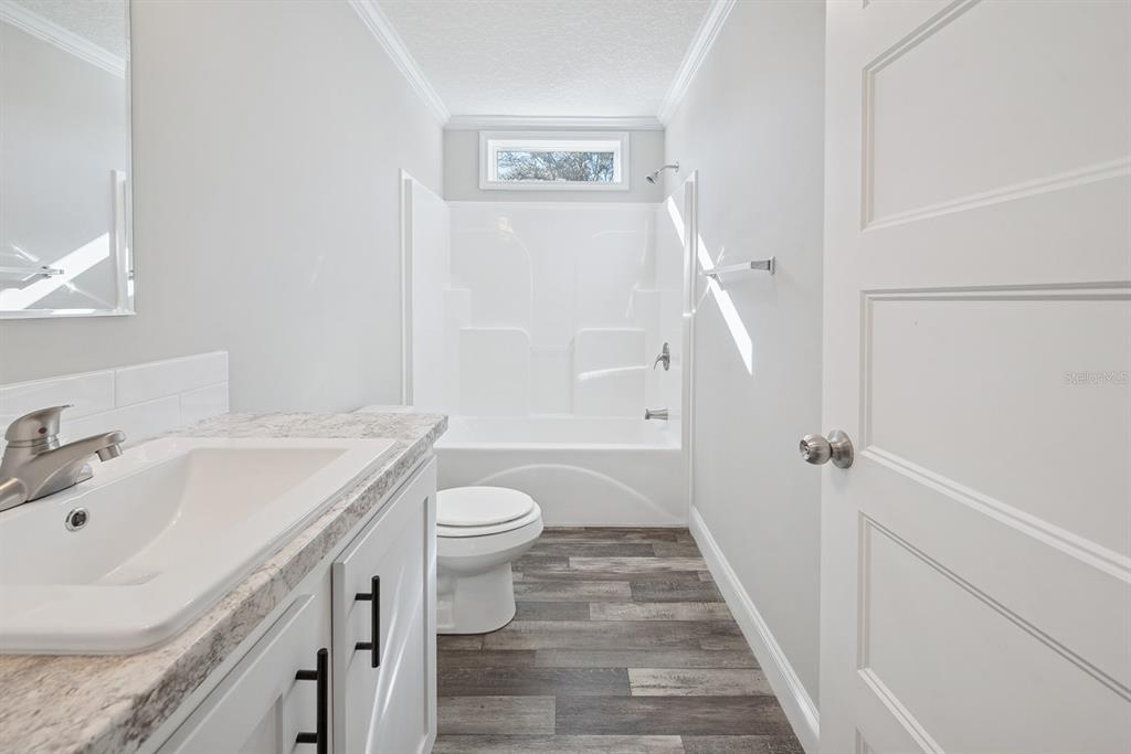 19750 Southeast 30th Street Morriston, FL 32668 - Photo 51 of 52 a bathroom with a sink toilet and shower