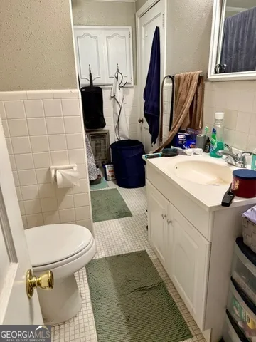 a bathroom with a sink toilet and mirror