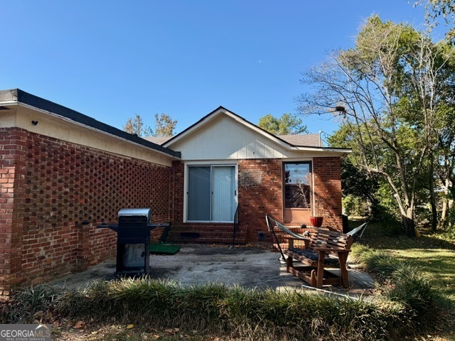 405 South Leroy Street Metter, GA 30439 - Photo 16 of 18 a backyard of a house with table and chairs