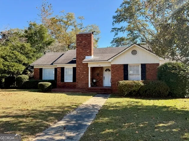 a front view of a house with yard and garage