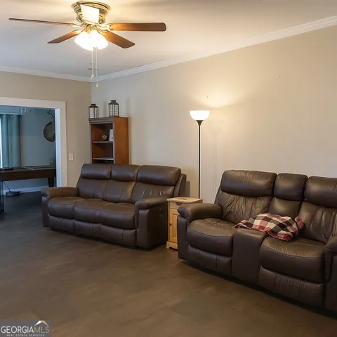 a living room with furniture and a chandelier
