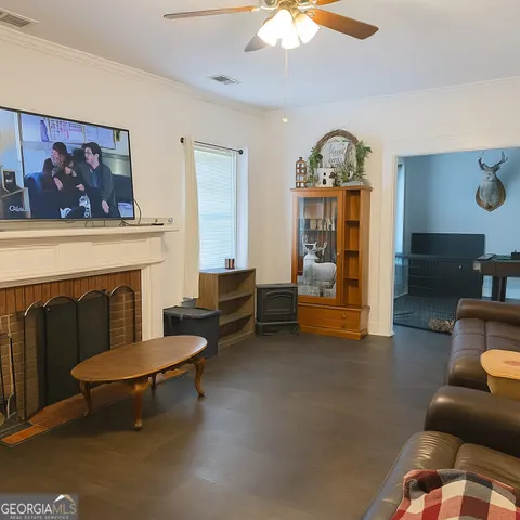 a living room with furniture a rug and a fireplace