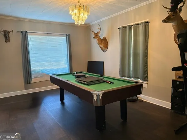 a view of a room with furniture and wooden floor