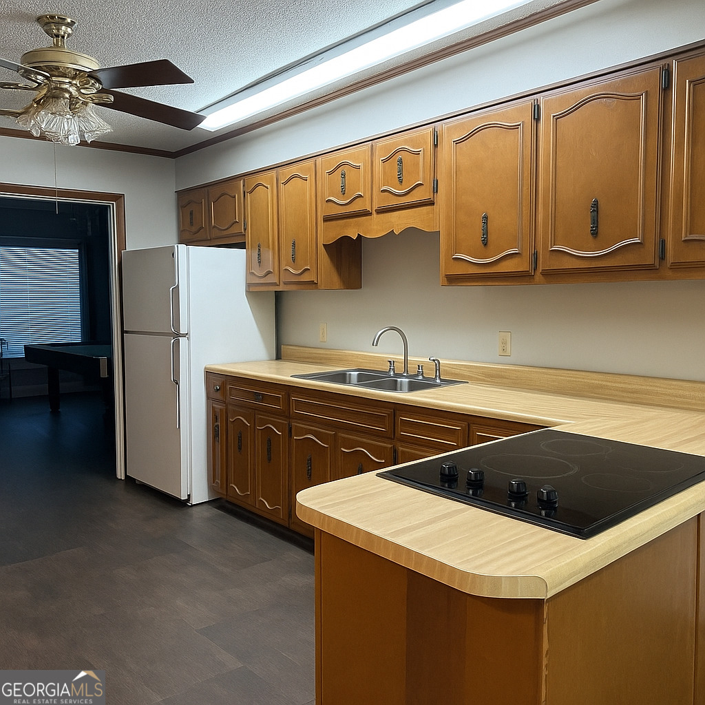 405 South Leroy Street Metter, GA 30439 - Photo 5 of 18 a utility room with stainless steel appliances a stove a refrigerator and cabinets