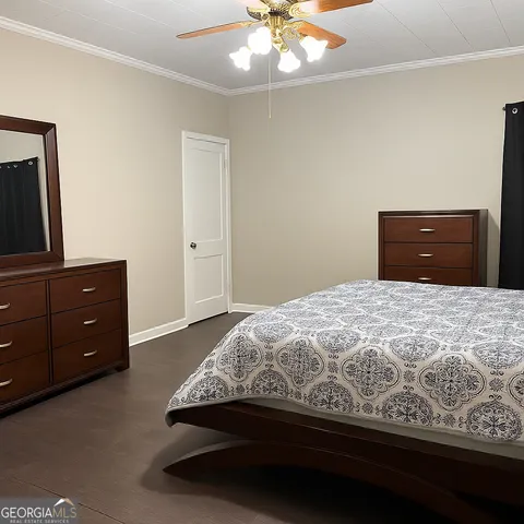 a bedroom with a bed and dresser