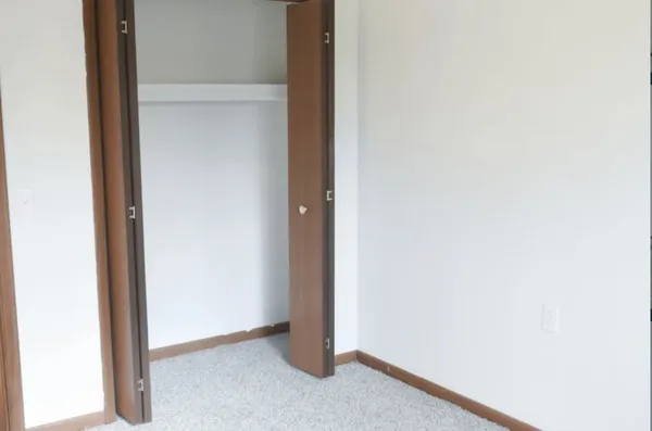 a view of a small space with wooden floor and a window