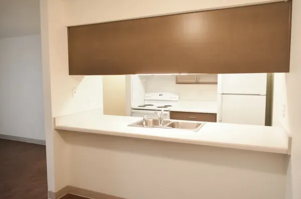 a kitchen with a refrigerator and a stove