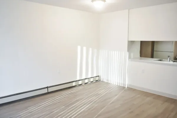 a view of a room with wooden floor