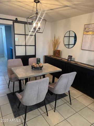 a view of a dining room with furniture and window