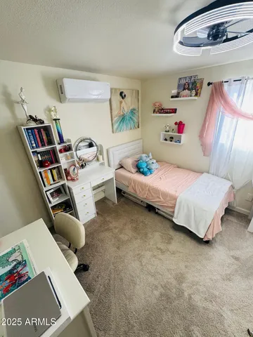 a bedroom with furniture and a book shelf