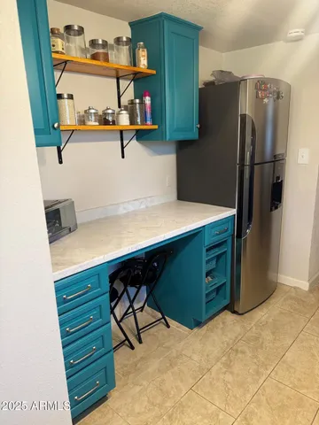 a room with cabinets and a refrigerator