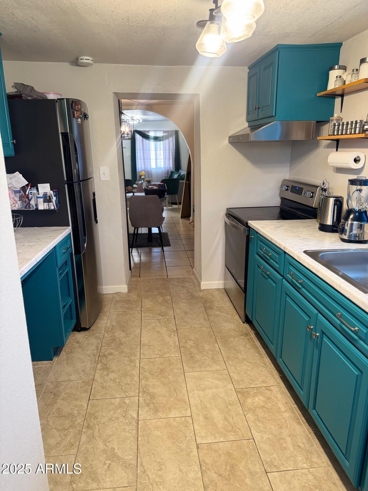 735 East 3rd Street Douglas, AZ 85607 - Photo 8 of 18 a kitchen with a cabinets and a stove top oven