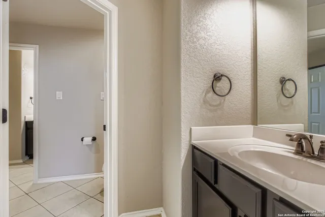 a bathroom with a sink a toilet and mirror