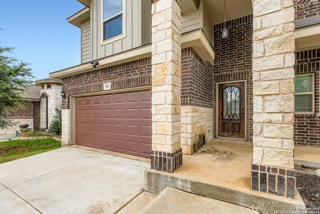 a view of a brick house with a yard