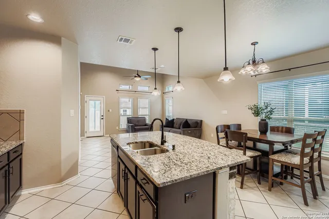 a kitchen with a table and chairs in it
