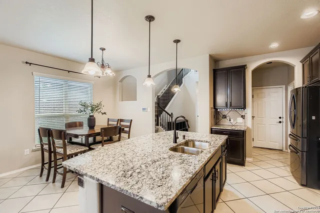 a view of a kitchen area kitchen island dining table and chairs