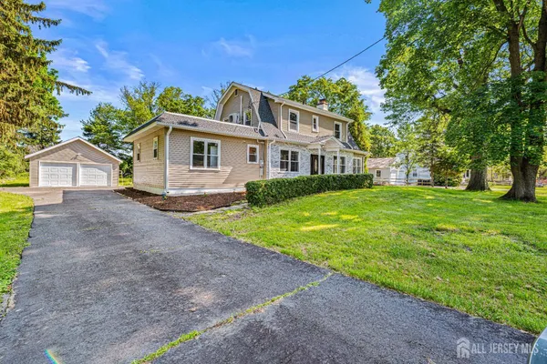 a front view of house with yard and green space