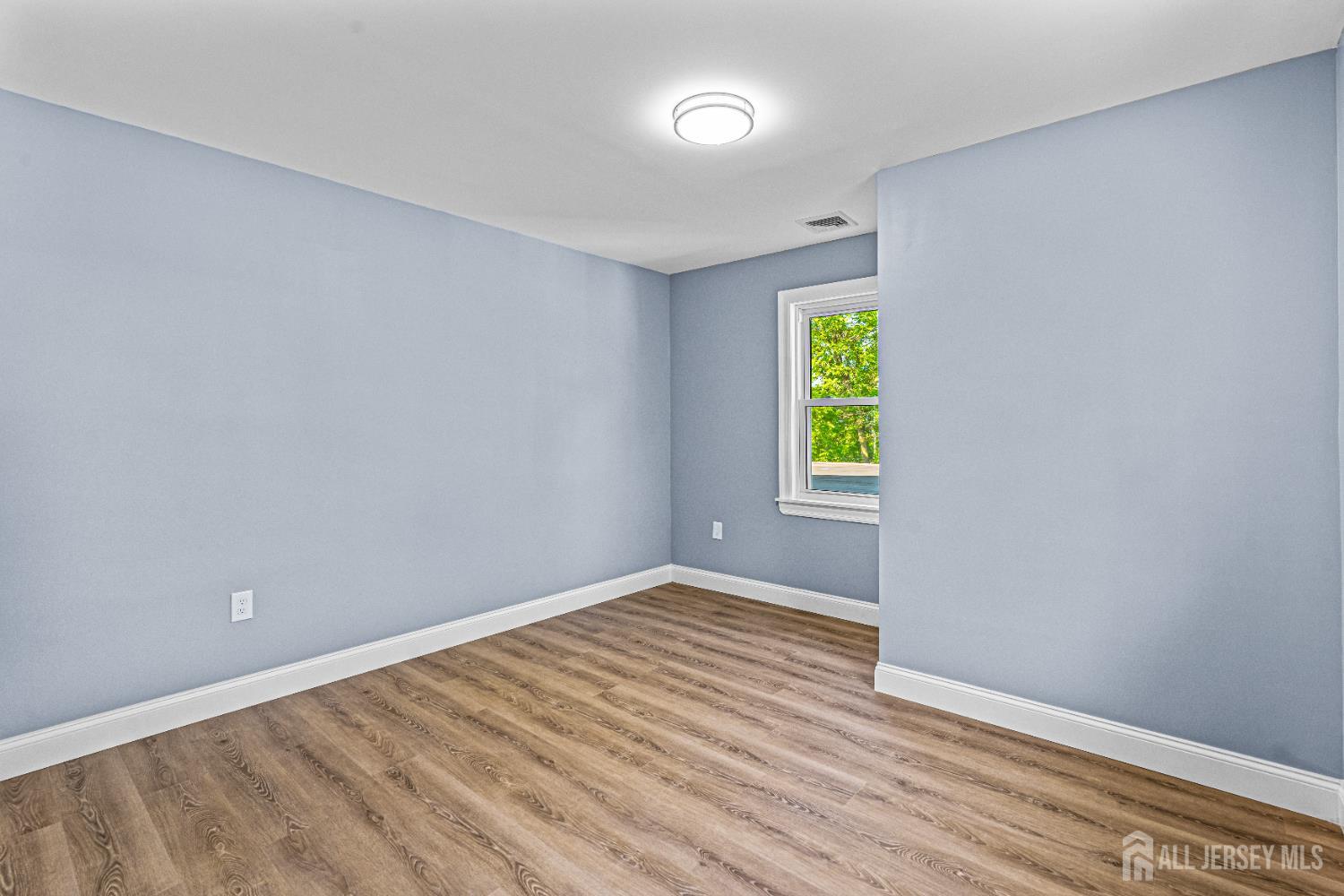 790 Ridge Road Monmouth Junction, NJ 08852 - Photo 15 of 38 a view of an empty room with window and wooden floor