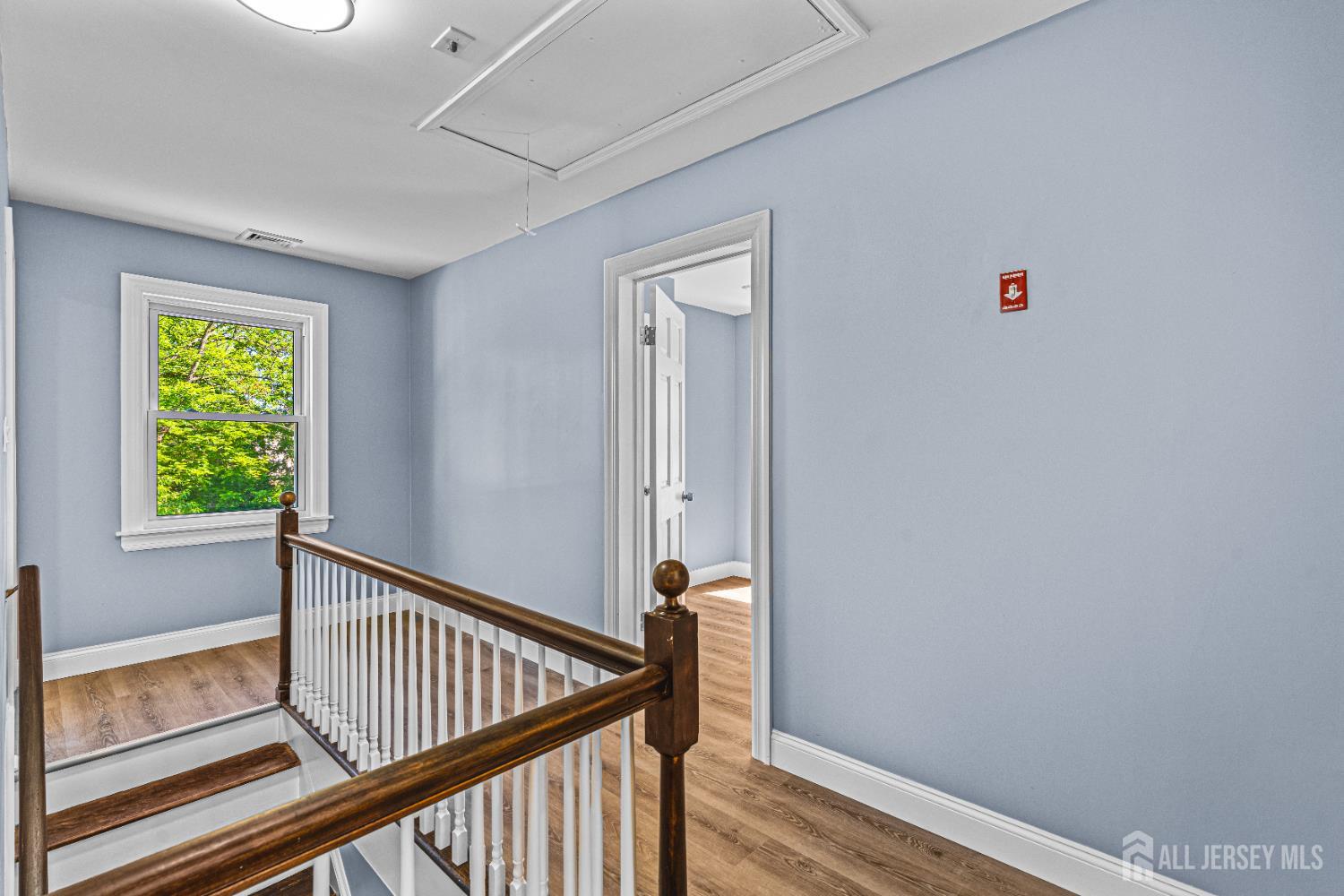790 Ridge Road Monmouth Junction, NJ 08852 - Photo 16 of 38 a view of a hallway with wooden floor and stairs