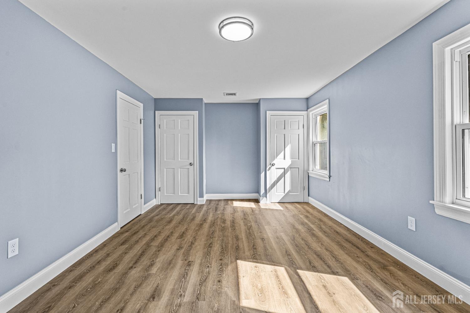 790 Ridge Road Monmouth Junction, NJ 08852 - Photo 21 of 38 a view of an empty room with wooden floor and a window