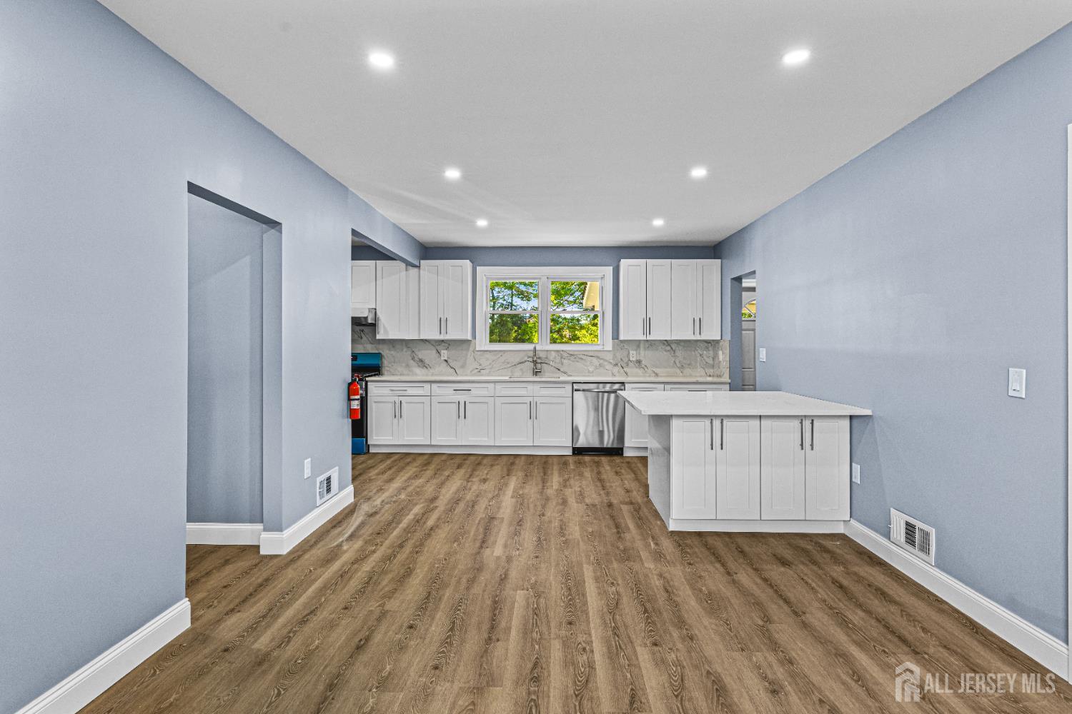 790 Ridge Road Monmouth Junction, NJ 08852 - Photo 27 of 38 a kitchen with wooden floors and white cabinets