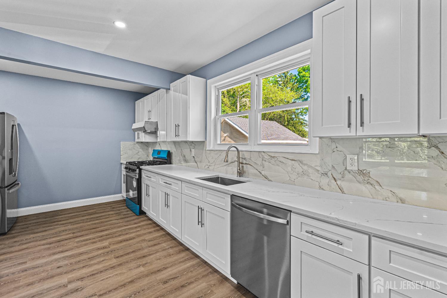 790 Ridge Road Monmouth Junction, NJ 08852 - Photo 31 of 38 a kitchen with a sink window and cabinets