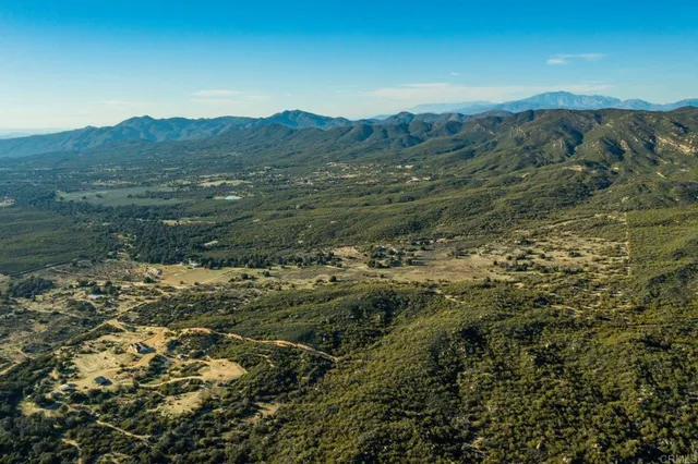 a view of a mountain in the distance in a field