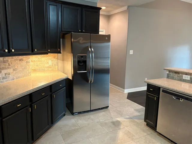 a kitchen with a sink and a stove top oven with wooden floor