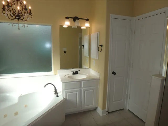 a bathroom with a sink a mirror and a bathtub