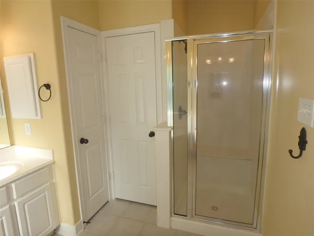 a bathroom with a shower and a sink