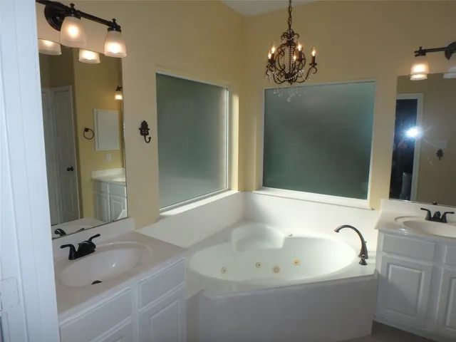 a bathroom with a sink a mirror and a bathtub