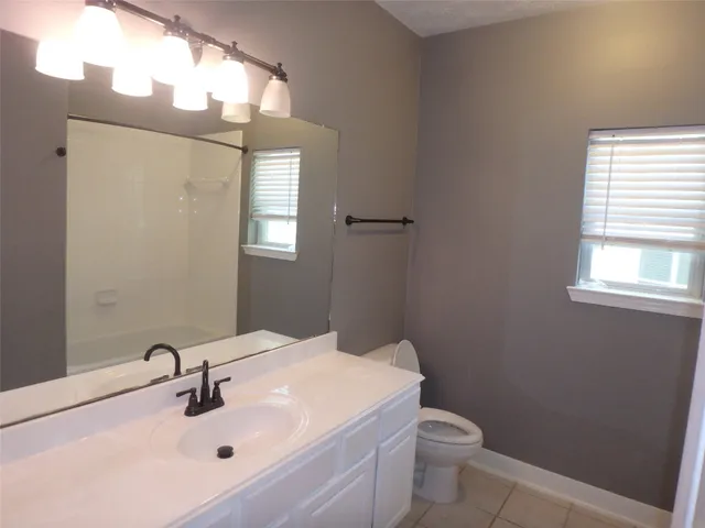 a bathroom with a shower and a sink