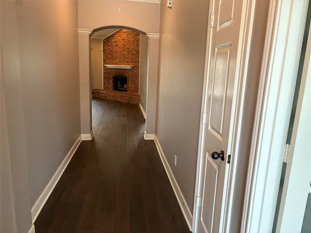 a view of hallway with stairs and wooden floor