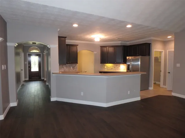 a large room with lots of counter space and wooden floor