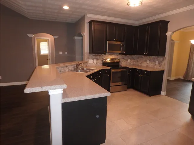 a kitchen with a sink a stove and refrigerator
