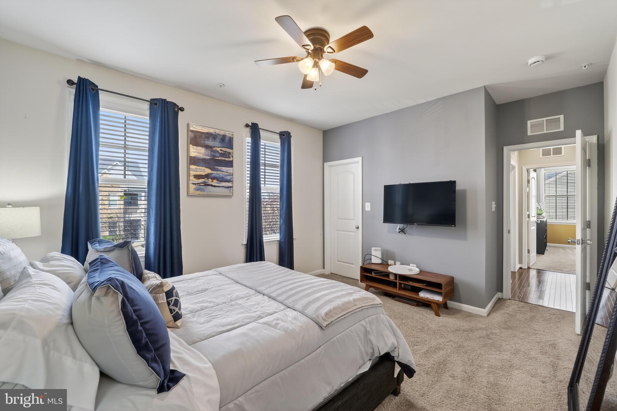 9205 Rice Avenue Lanham, MD 20706 - Photo 29 of 68 a bedroom with a bed and a flat screen tv