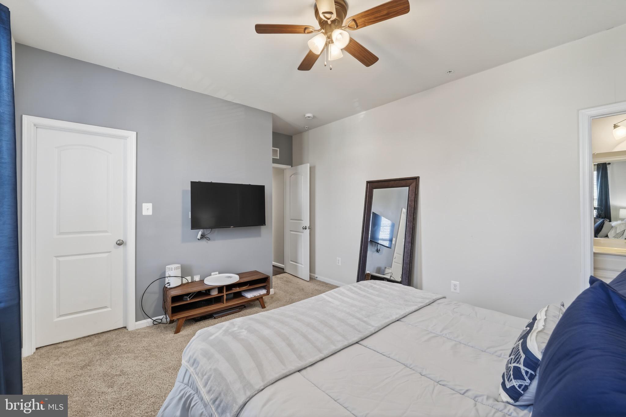 9205 Rice Avenue Lanham, MD 20706 - Photo 30 of 68 a bedroom with a bed and a flat screen tv